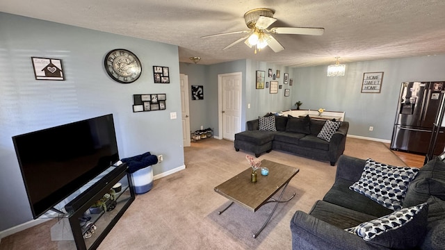 carpeted living room featuring baseboards, a textured ceiling, and a ceiling fan