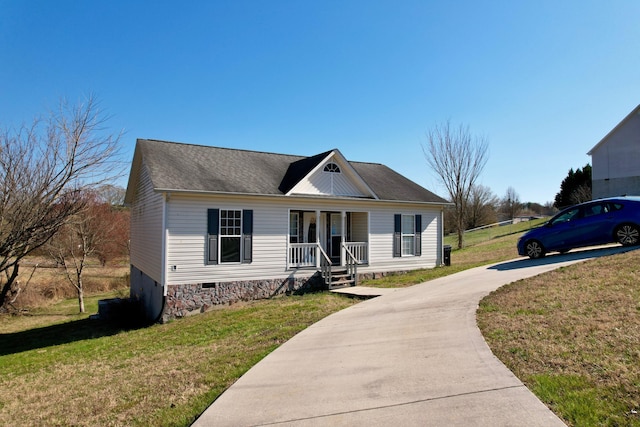 view of front facade featuring a front yard, covered porch, driveway, and crawl space