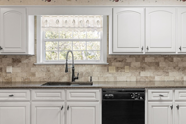 kitchen with white cabinets, sink, black dishwasher, and tasteful backsplash