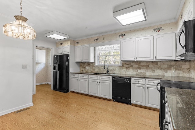 kitchen featuring black appliances, sink, light hardwood / wood-style flooring, decorative light fixtures, and white cabinetry