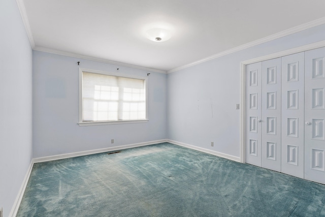 carpeted spare room featuring crown molding