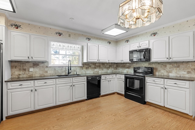 kitchen featuring white cabinetry, sink, light hardwood / wood-style flooring, decorative backsplash, and black appliances