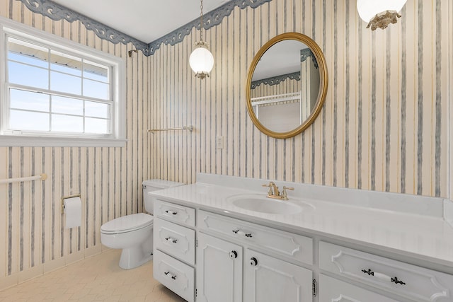 bathroom featuring tile patterned flooring, vanity, and toilet