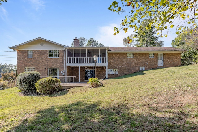 back of house with a sunroom and a yard