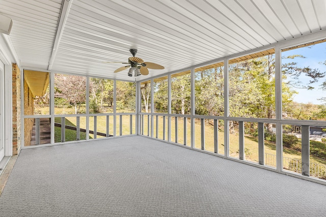 unfurnished sunroom with ceiling fan