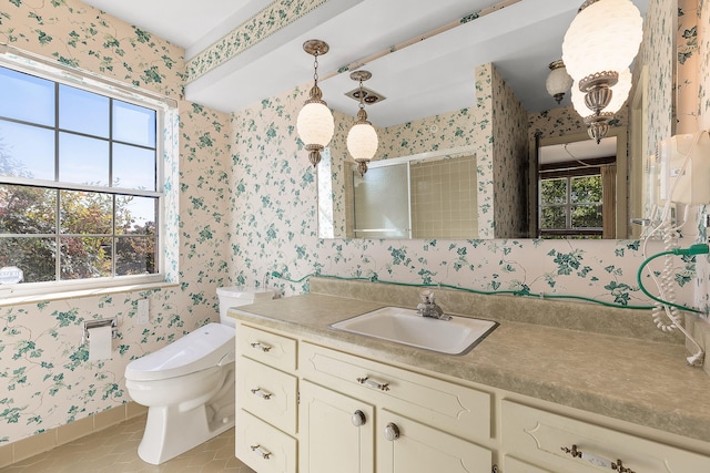 bathroom with tile patterned floors, vanity, a shower with shower door, and toilet