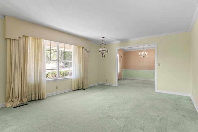 empty room featuring carpet flooring, crown molding, and an inviting chandelier