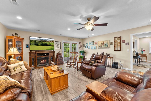 407 Kahite Trl, Vonore, TN 37885 - living area with ceiling fan, light wood-style floors, a warm lit fireplace, recessed lighting, and baseboards