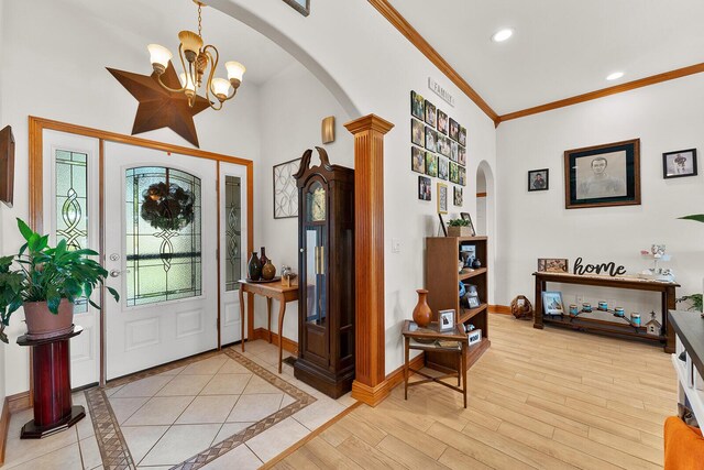 407 Kahite Trl, Vonore, TN 37885 - entryway with arched walkways, a chandelier, decorative columns, crown molding, and baseboards