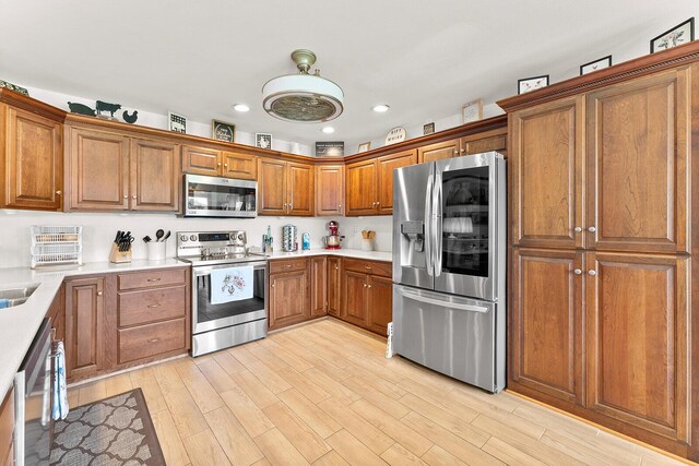407 Kahite Trl, Vonore, TN 37885 - kitchen featuring appliances with stainless steel finishes, brown cabinets, light wood-style flooring, recessed lighting, and light countertops