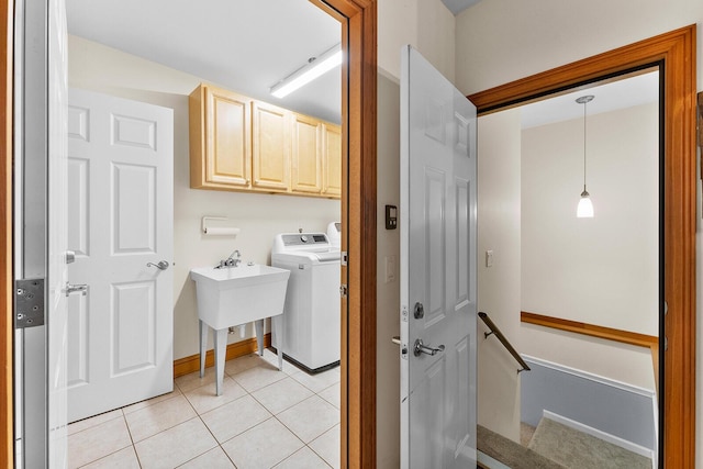 407 Kahite Trl, Vonore, TN 37885 - washroom featuring cabinet space, light tile patterned floors, washer and clothes dryer, and baseboards