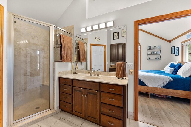 407 Kahite Trl, Vonore, TN 37885 - ensuite bathroom featuring lofted ceiling, a shower stall, vanity, and tile patterned floors