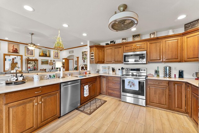 407 Kahite Trl, Vonore, TN 37885 - kitchen with stainless steel appliances, a sink, brown cabinets, a ceiling fan, and light countertops