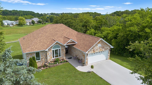 407 Kahite Trl, Vonore, TN 37885 - single story home with stone siding, an attached garage, concrete driveway, a front yard, and a view of trees