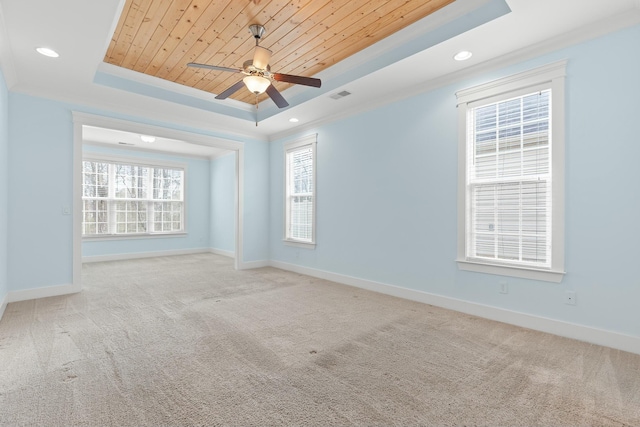 spare room featuring light colored carpet, ornamental molding, a tray ceiling, and wooden ceiling