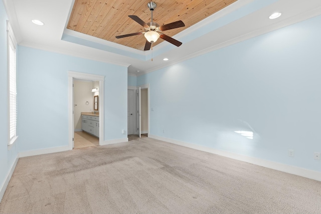 unfurnished bedroom featuring light carpet, wood ceiling, ornamental molding, and a raised ceiling