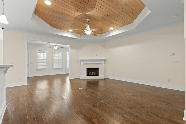 unfurnished living room with dark hardwood / wood-style floors, a fireplace, a raised ceiling, crown molding, and wooden ceiling