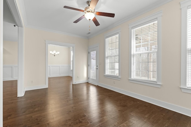 foyer entrance featuring crown molding, ceiling fan with notable chandelier, and dark wood-type flooring