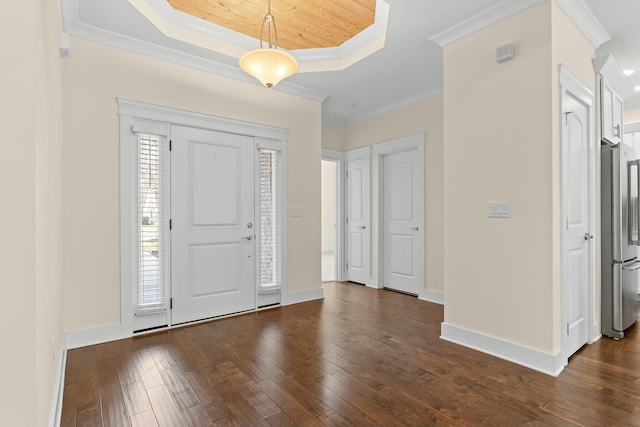 entrance foyer featuring crown molding, dark hardwood / wood-style floors, and a tray ceiling