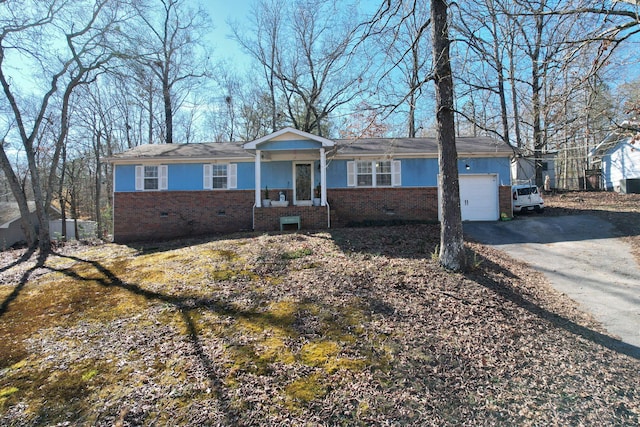 ranch-style home with aphalt driveway, crawl space, brick siding, and a garage