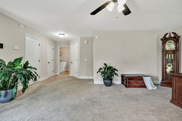 1851 Preservation Dr NE, Cleveland, TN 37323 - living area featuring carpet flooring, a ceiling fan, baseboards, and washing machine and clothes dryer