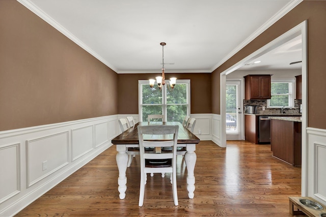 1851 Preservation Dr NE, Cleveland, TN 37323 - dining area featuring a decorative wall, a chandelier, a wainscoted wall, ornamental molding, and wood finished floors