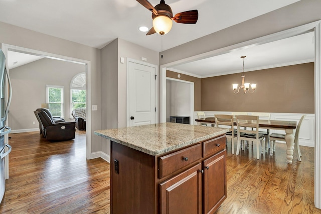 1851 Preservation Dr NE, Cleveland, TN 37323 - kitchen featuring light wood-style flooring, a ceiling fan, hanging light fixtures, a chandelier, and light stone counters