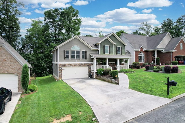 1851 Preservation Dr NE, Cleveland, TN 37323 - view of front of home featuring covered porch, concrete driveway, a front yard, and stone siding