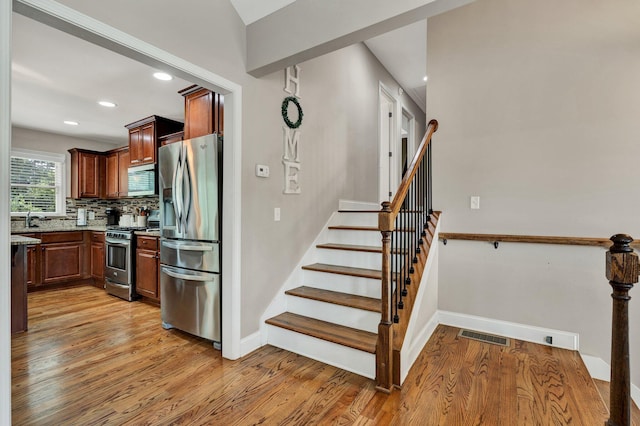 1851 Preservation Dr NE, Cleveland, TN 37323 - stairs featuring baseboards, wood finished floors, and recessed lighting