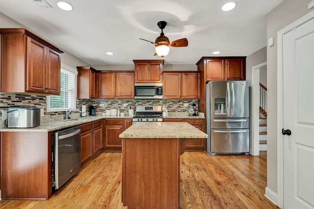 1851 Preservation Dr NE, Cleveland, TN 37323 - kitchen with appliances with stainless steel finishes, light wood-style floors, a sink, tasteful backsplash, and recessed lighting