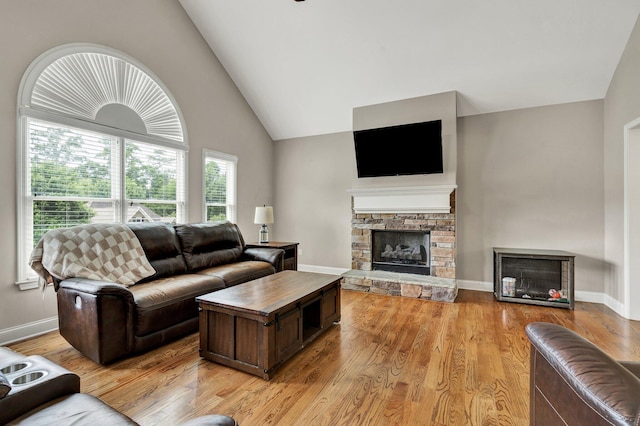 1851 Preservation Dr NE, Cleveland, TN 37323 - living area with a stone fireplace, high vaulted ceiling, light wood-style flooring, and baseboards