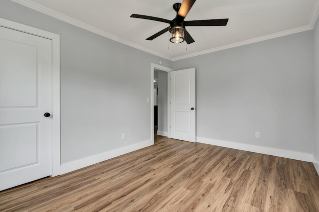 unfurnished bedroom featuring baseboards, wood finished floors, ornamental molding, and ceiling fan