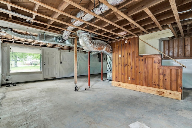 basement featuring wood walls