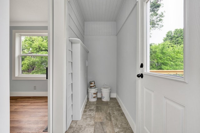 bathroom featuring crown molding, baseboards, and a healthy amount of sunlight