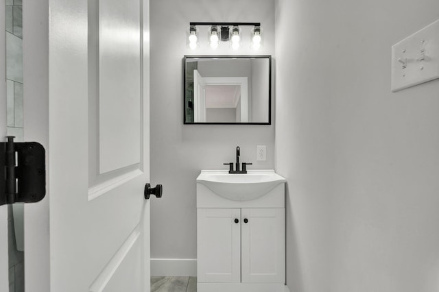 bathroom with baseboards and vanity
