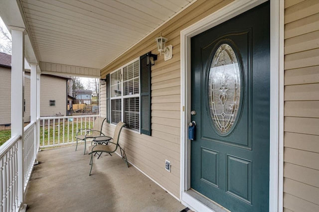 single story home featuring a porch and a garage