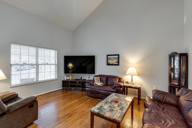 living room with ceiling fan, dark hardwood / wood-style floors, and lofted ceiling