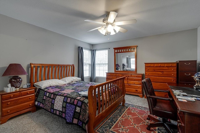 bedroom featuring ceiling fan and dark carpet