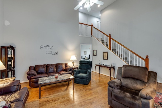 living room with dark hardwood / wood-style floors, ceiling fan with notable chandelier, and vaulted ceiling