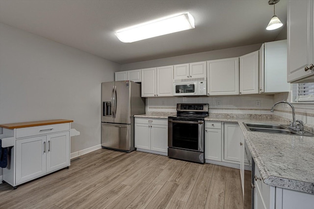 washroom with washing machine and dryer and cabinets