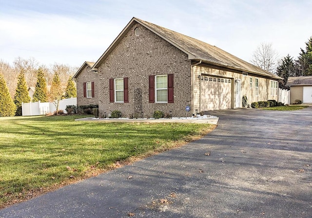 view of property exterior featuring a garage and a lawn