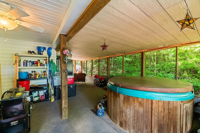 sunroom / solarium with plenty of natural light, ceiling fan, and a jacuzzi