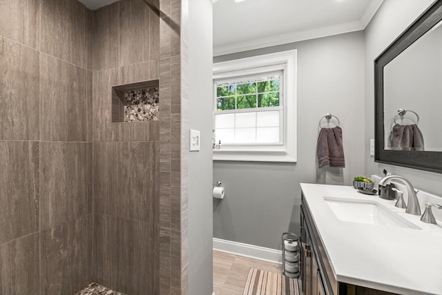 bathroom featuring hardwood / wood-style flooring, vanity, crown molding, and walk in shower