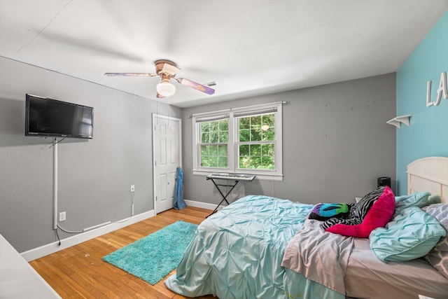 bedroom featuring hardwood / wood-style flooring and ceiling fan