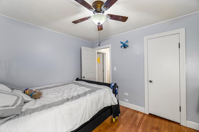 bedroom with wood-type flooring and ceiling fan