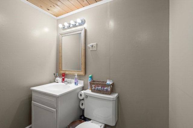 bathroom featuring ornamental molding, vanity, wood ceiling, and toilet