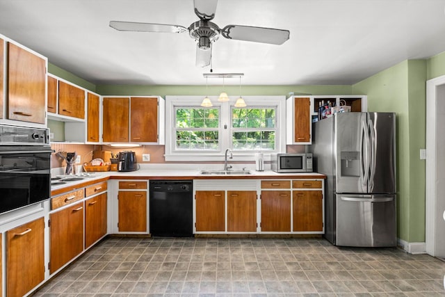 kitchen featuring sink, decorative light fixtures, ceiling fan, and black appliances