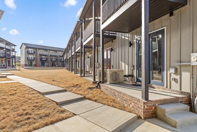 exterior space with a residential view, a patio, and ac unit