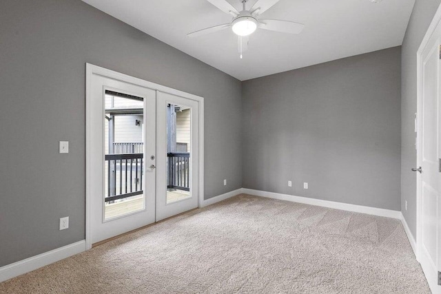 carpeted empty room featuring ceiling fan and french doors