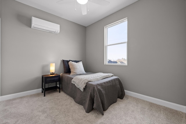 bedroom with light carpet, a wall mounted air conditioner, a ceiling fan, and baseboards